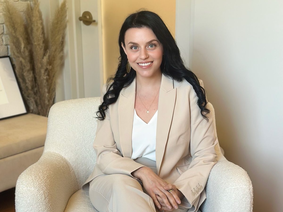 Skyler Laliberte seated in a cream armchair in a warm, neutral office